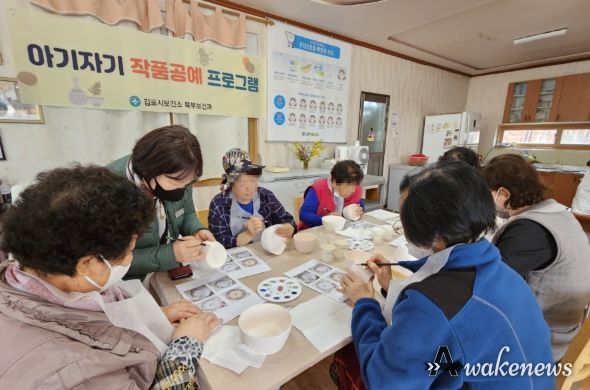 책상에 둘러 앉은 주민들이 공예 프로그램에 집중하고 있다.